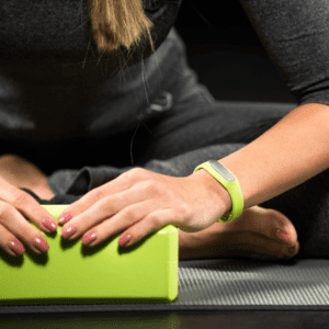 Hands on a yoga block used as support for coming home in your body