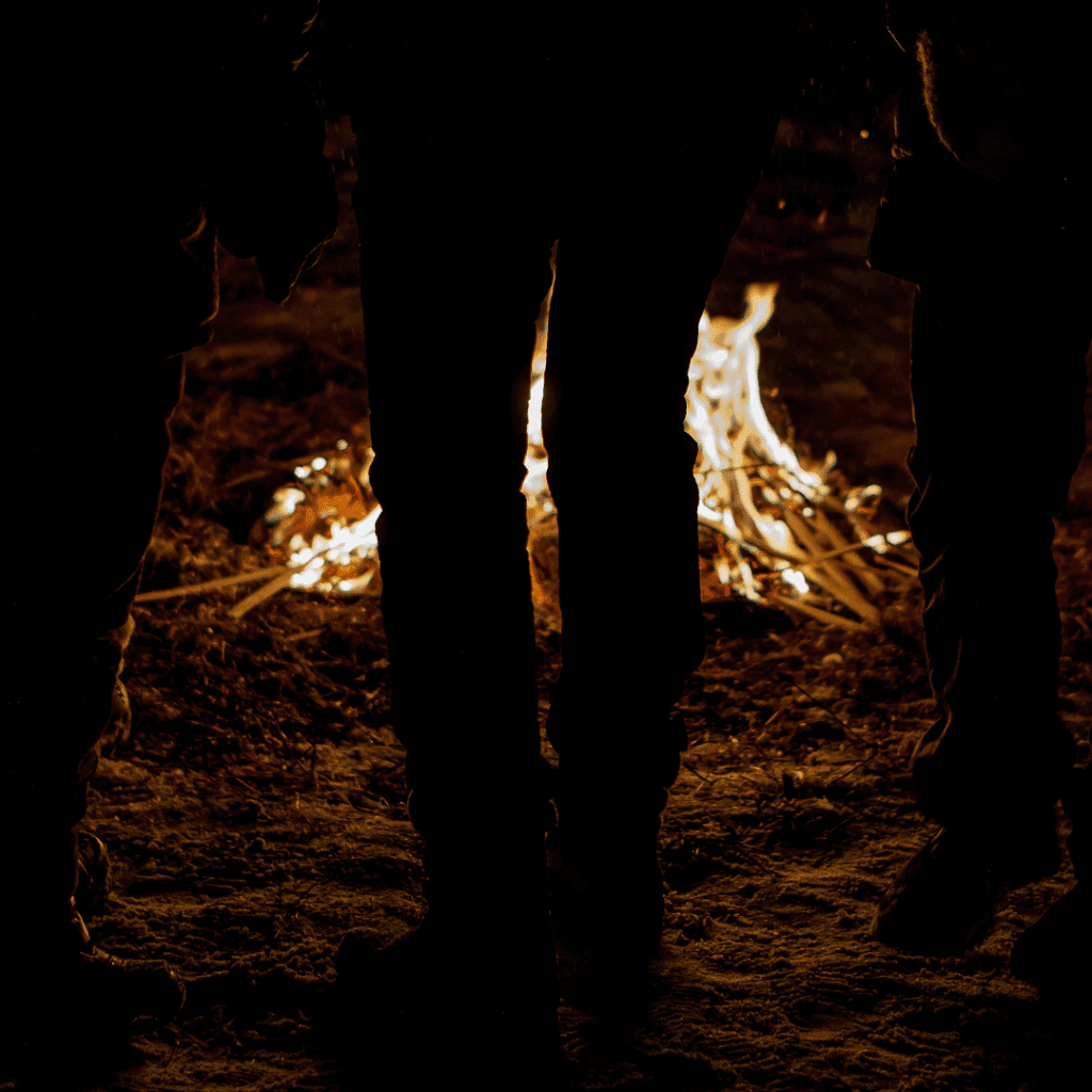 A group gathers around a fire to find connection